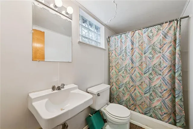 a bathroom with a sink toilet and mirror