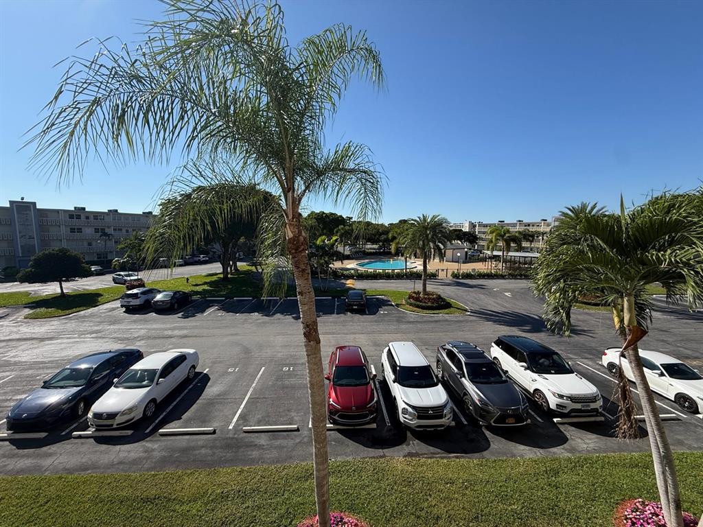3022 Ainslie Drive, Unit 3022 Boca Raton, FL 33434 - Photo 2 of 29 a view of a swimming pool with lawn chairs