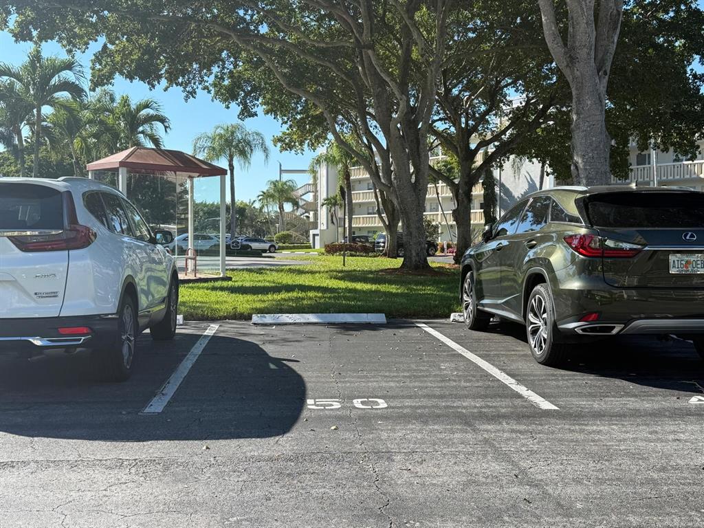 3022 Ainslie Drive, Unit 3022 Boca Raton, FL 33434 - Photo 22 of 29 a view of a street with a large tree