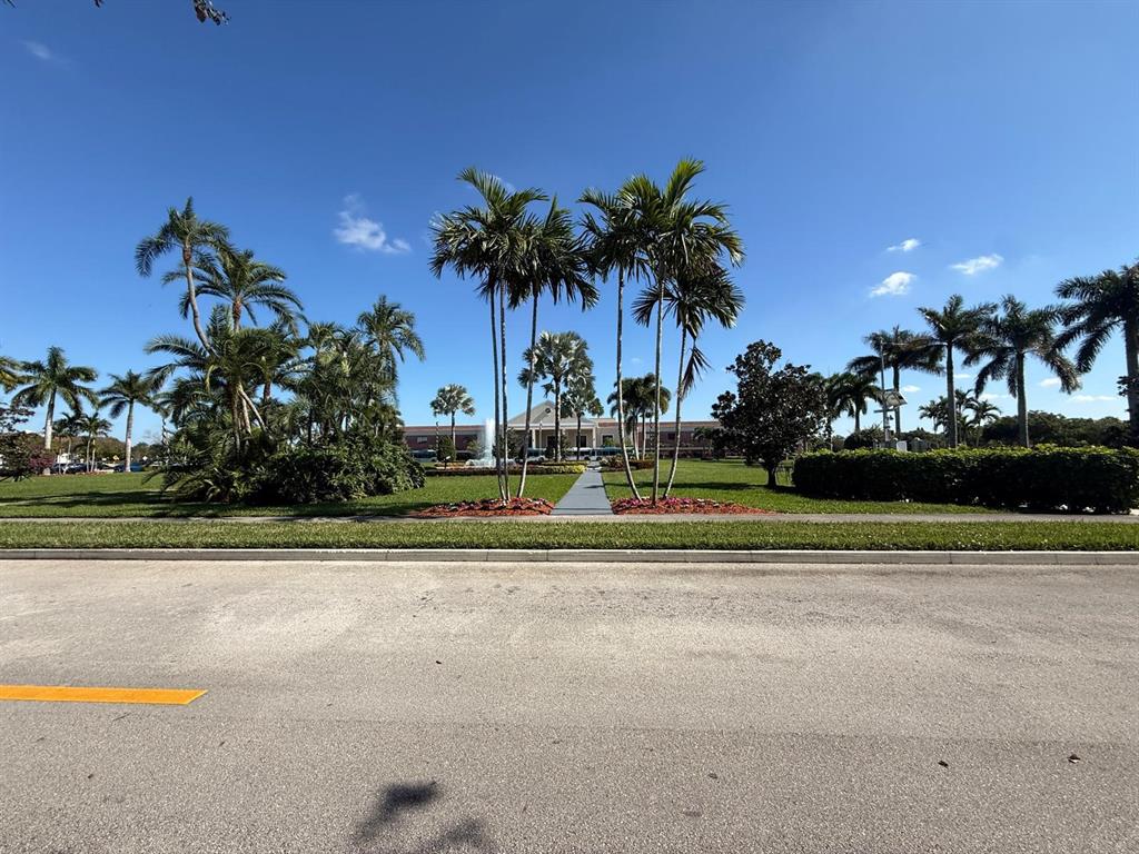 3022 Ainslie Drive, Unit 3022 Boca Raton, FL 33434 - Photo 26 of 29 a view of a fountain in front of a house with a big yard