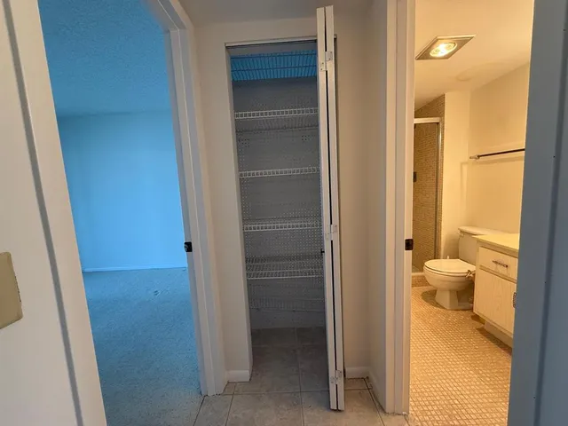 a bathroom with a granite countertop sink toilet and a shower