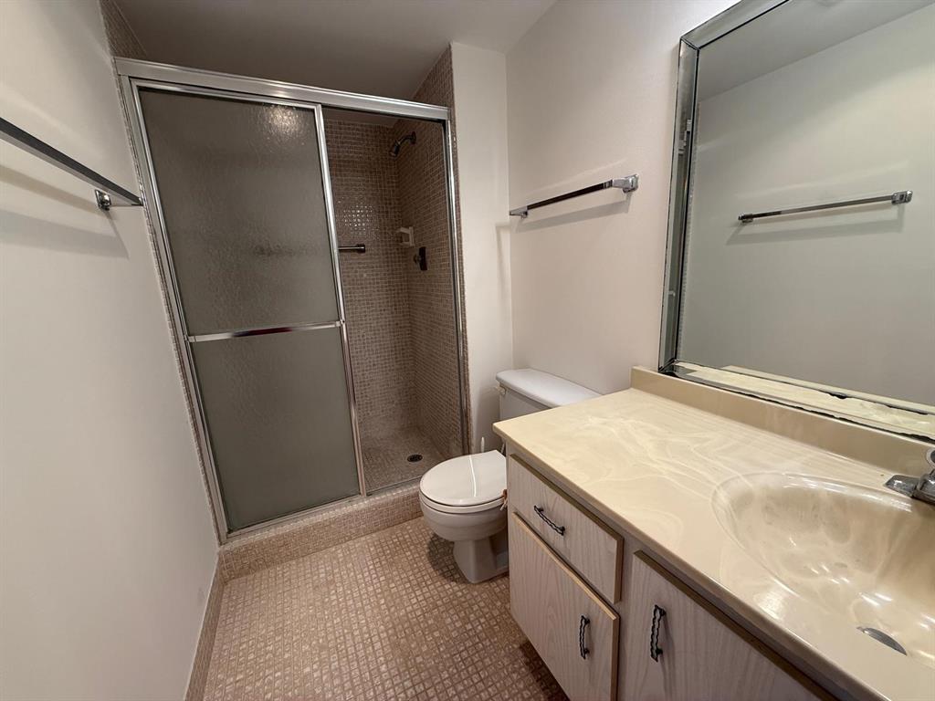 3022 Ainslie Drive, Unit 3022 Boca Raton, FL 33434 - Photo 8 of 29 a bathroom with a granite countertop sink toilet and a shower