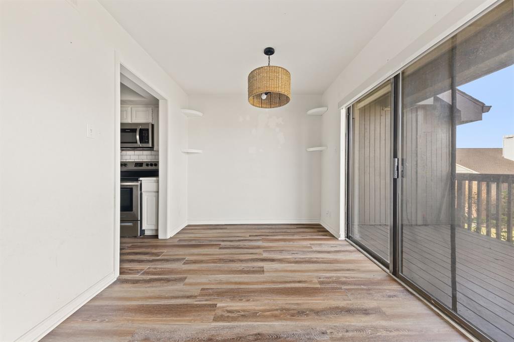 1238 Signal Ridge Place Rockwall, TX 75032 - Photo 16 of 32 a view of a hallway with wooden floor and staircase