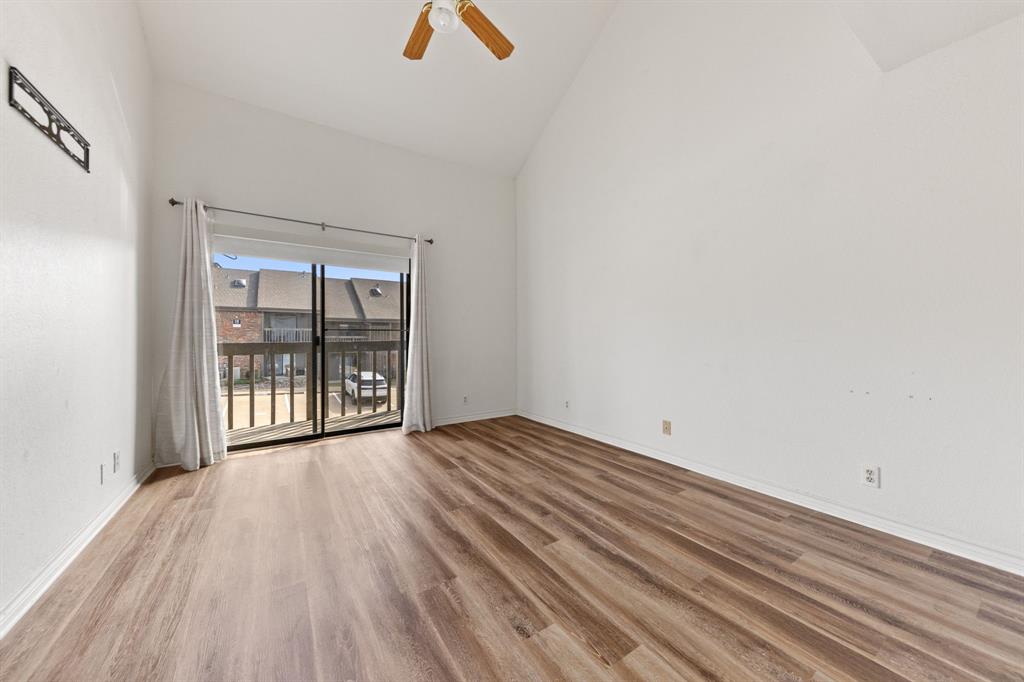 1238 Signal Ridge Place Rockwall, TX 75032 - Photo 17 of 32 a view of an empty room with wooden floor and a window