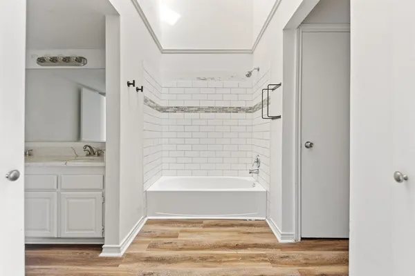 a bathroom with a bathtub and shower