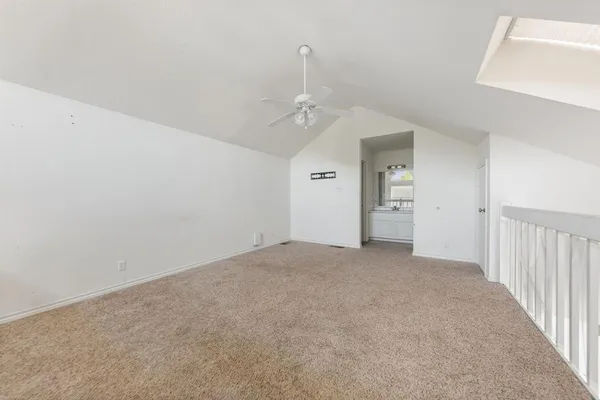 an empty room with a windows and cabinet