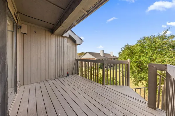 a view of balcony with wooden floor