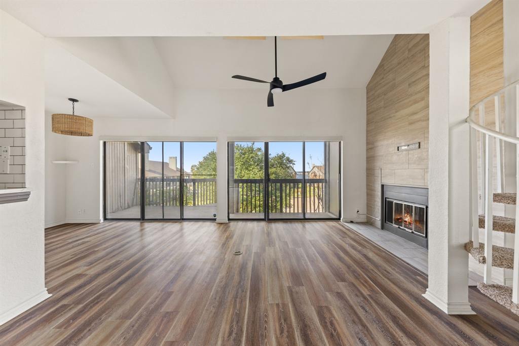 1238 Signal Ridge Place Rockwall, TX 75032 - Photo 9 of 32 a view of empty room with wooden floor and fireplace
