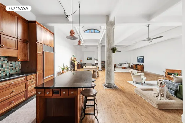 a kitchen with stainless steel appliances granite countertop a sink dishwasher and a dining table with cabinets