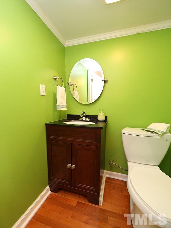 412 Southeast Maynard Road Cary, NC 27511 - Photo 9 of 19 Updated Powder Room with new Granite topped Cabinet, lighting and a high efficiency dual flush, chair-height toilet!