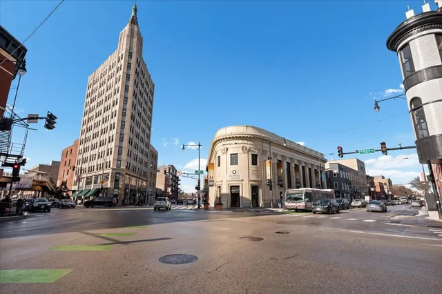a view of a tall building next to a road
