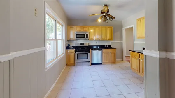 a kitchen with a stove a sink and a refrigerator