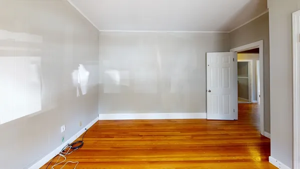 a room with wooden floor and a window