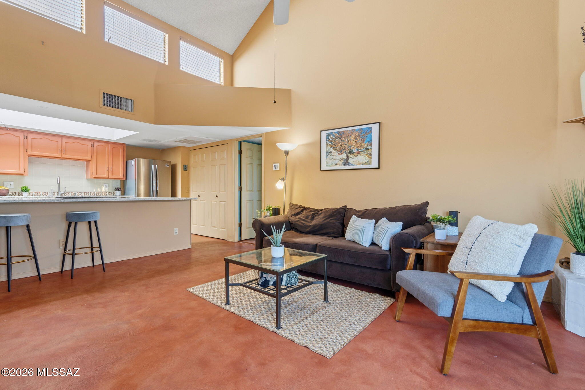 1200 East River Road, Unit G87 Tucson, AZ 85718 - Photo 8 of 30 a living room with furniture and a kitchen view