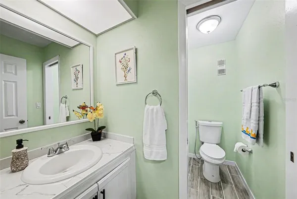 a bathroom with a sink toilet and mirror