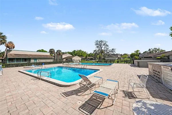 a view of a swimming pool and lounge chairs