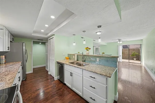 a kitchen with stainless steel appliances granite countertop a sink and stove