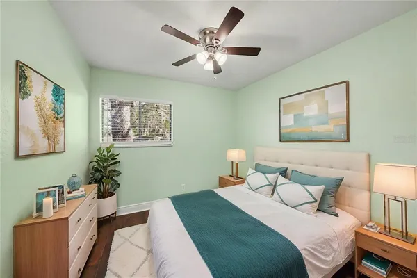 a bedroom with a bed and a chandelier