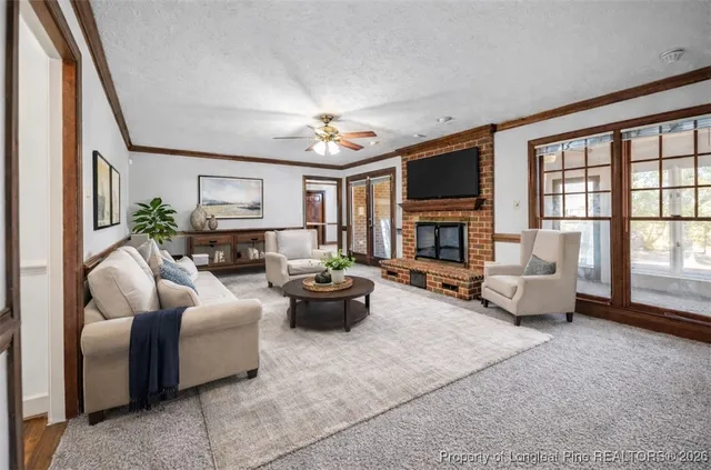 a view of an empty room with a chandelier fan