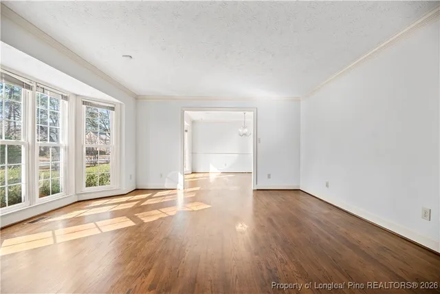 a view of a dining room with furniture wooden floor and a chandelier