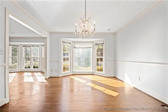 a view of a room with wooden floor and a window