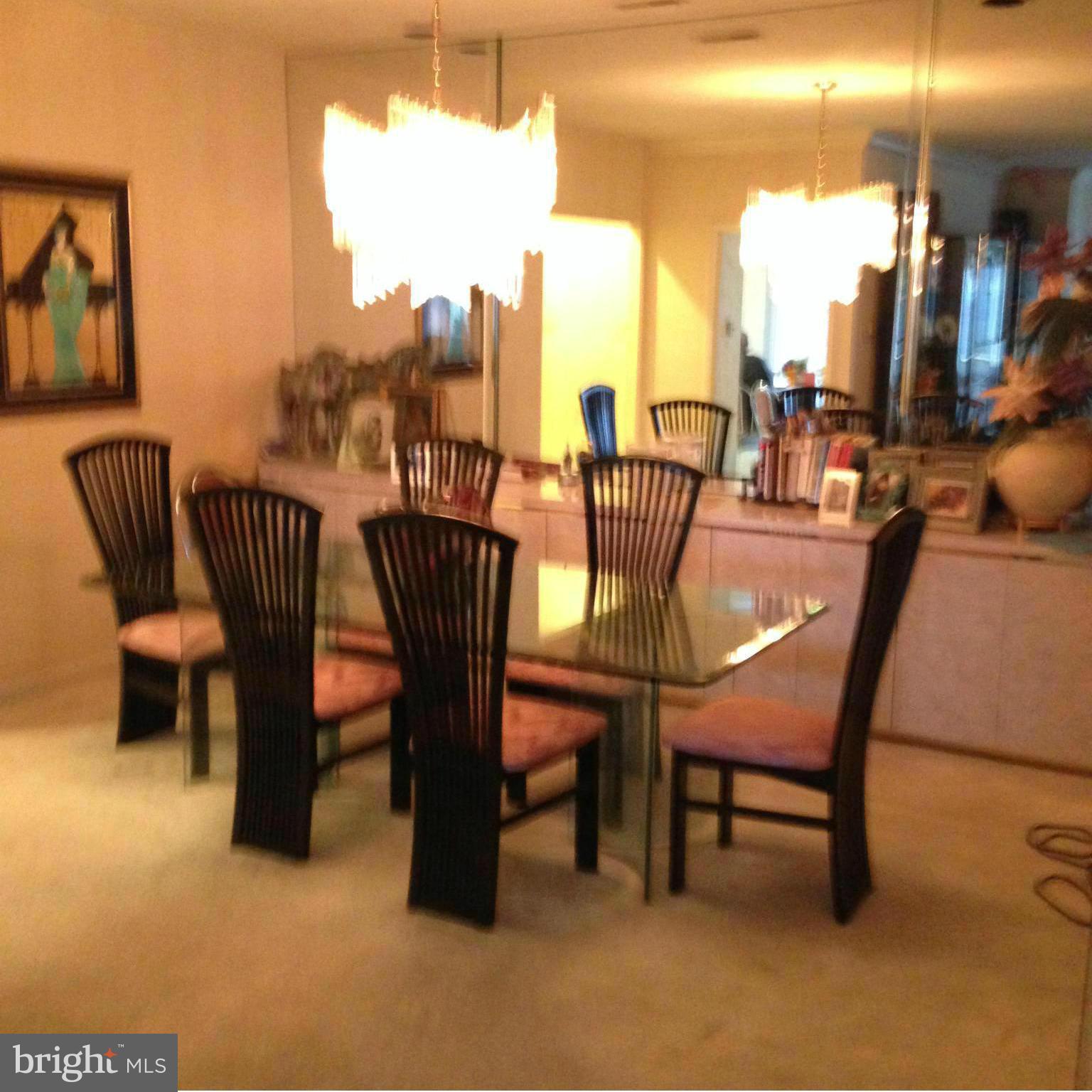 3031 Fallstaff Road, Unit 602C Baltimore, MD 21209 - Photo 4 of 13 a dining room with furniture and a floor to ceiling window