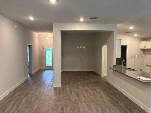a view of a kitchen with a sink and a refrigerator