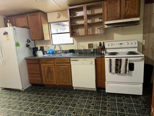 92 Vaughn Spur Northeast Cartersville, GA 30121 - Photo 35 of 50 a kitchen with a stove a sink and a refrigerator