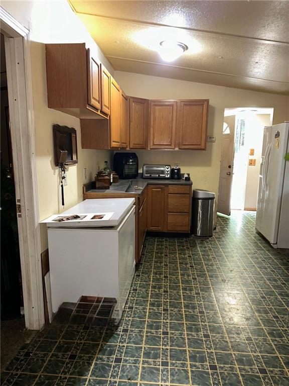 92 Vaughn Spur Northeast Cartersville, GA 30121 - Photo 41 of 50 a kitchen with a sink a stove and refrigerator