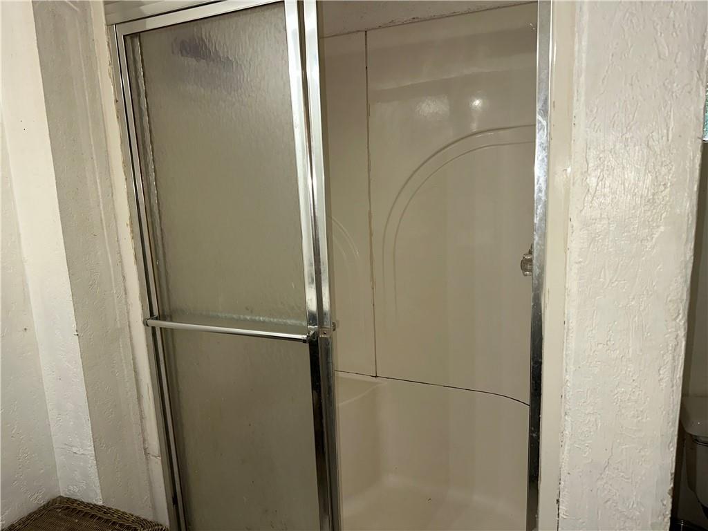 92 Vaughn Spur Northeast Cartersville, GA 30121 - Photo 44 of 50 a bathroom with a glass shower door