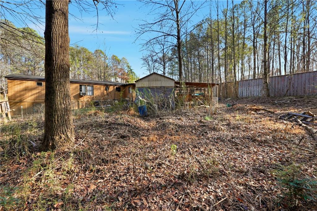 92 Vaughn Spur Northeast Cartersville, GA 30121 - Photo 9 of 50 a large tree is standing in front of a yard