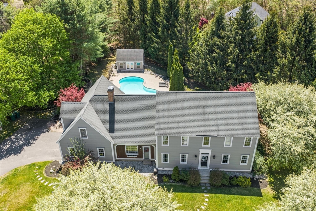 4 Ridge Road Pepperell, MA 01463 - Photo 2 of 42 an aerial view of a house with swimming pool and large trees