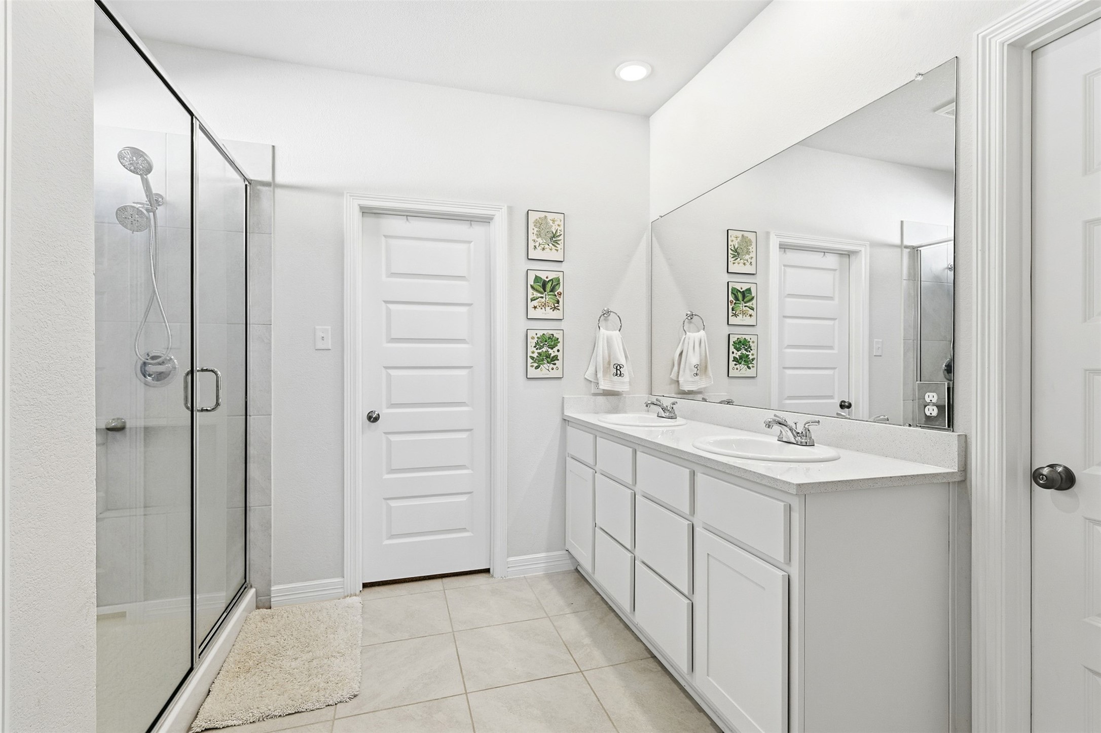 2773 Bluebonnet Ridge Drive Conroe, TX 77304 - Photo 9 of 23 a bathroom with a double vanity sink mirror and shower