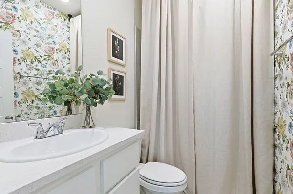 a bathroom with a glass shower door