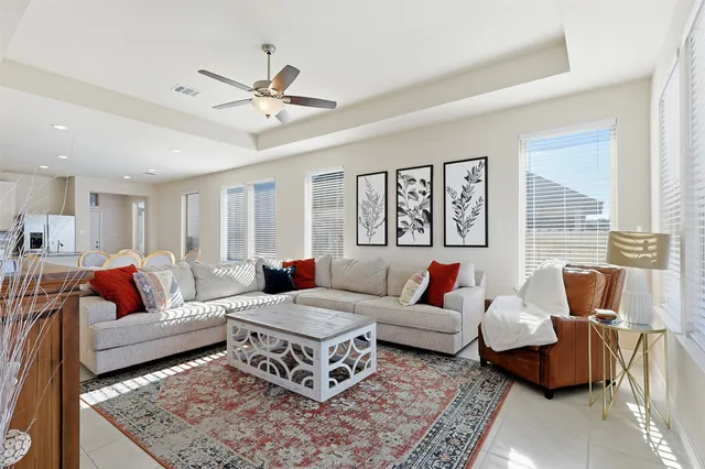 a kitchen with stainless steel appliances granite countertop a sink a stove a microwave a refrigerator and white cabinets