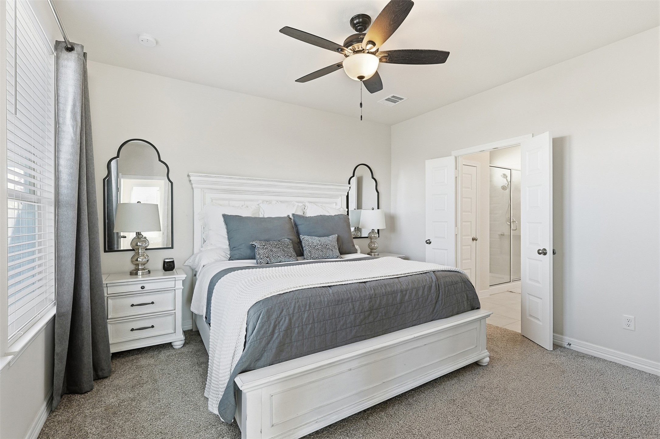 2773 Bluebonnet Ridge Drive Conroe, TX 77304 - Photo 7 of 23 a bedroom with a bed and a chandelier