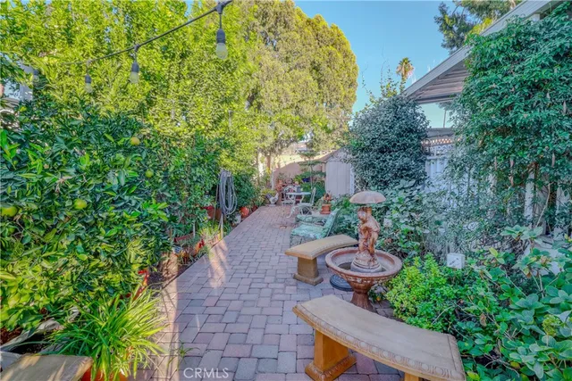 a view of a backyard with table and chairs and potted plants