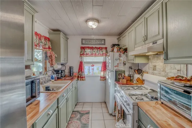 a kitchen with stainless steel appliances granite countertop a stove a sink dishwasher and cabinets