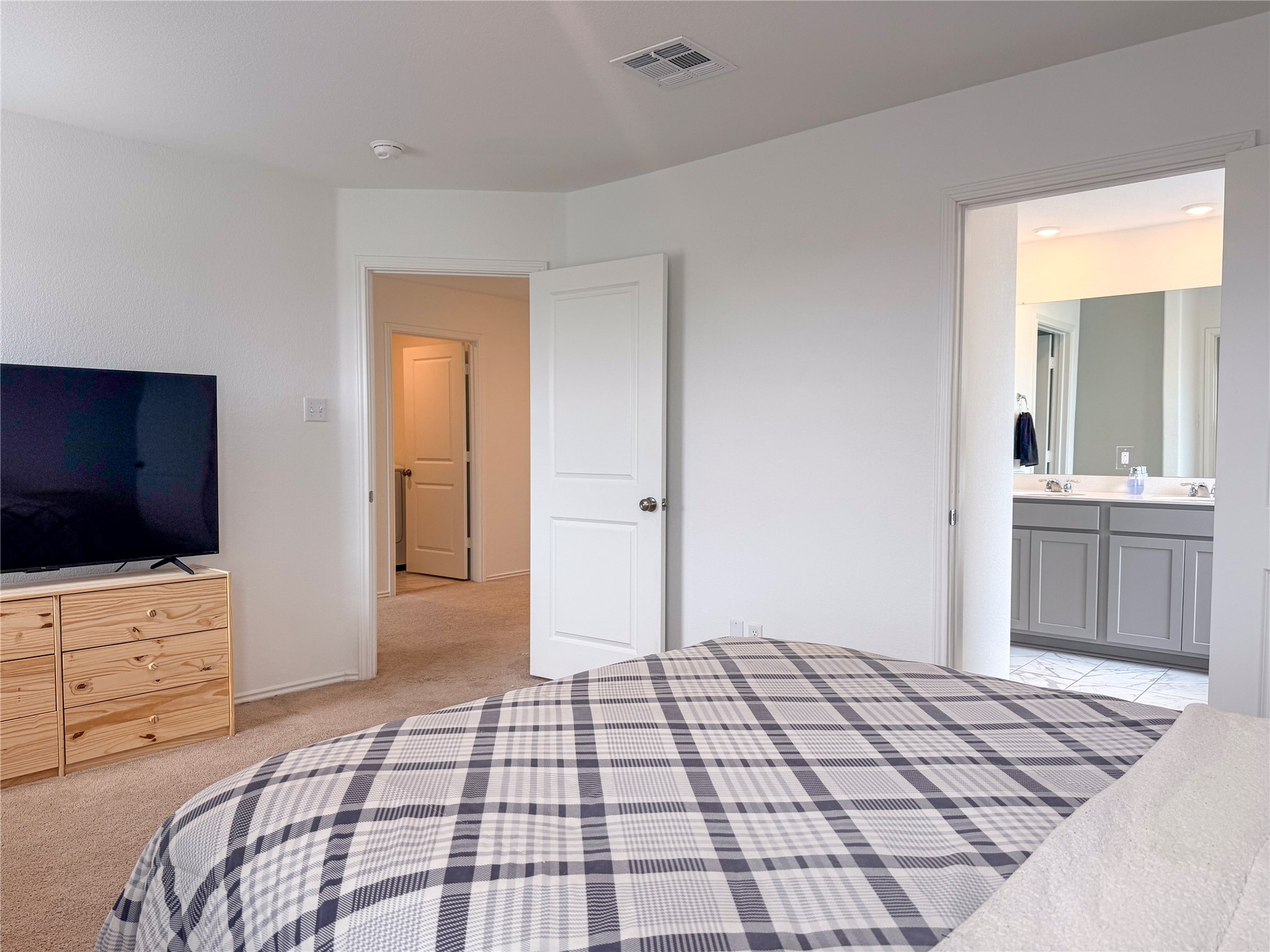 400 Canley Loop Hutto, TX 78634 - Photo 14 of 20 a bedroom with a bed and a flat screen tv