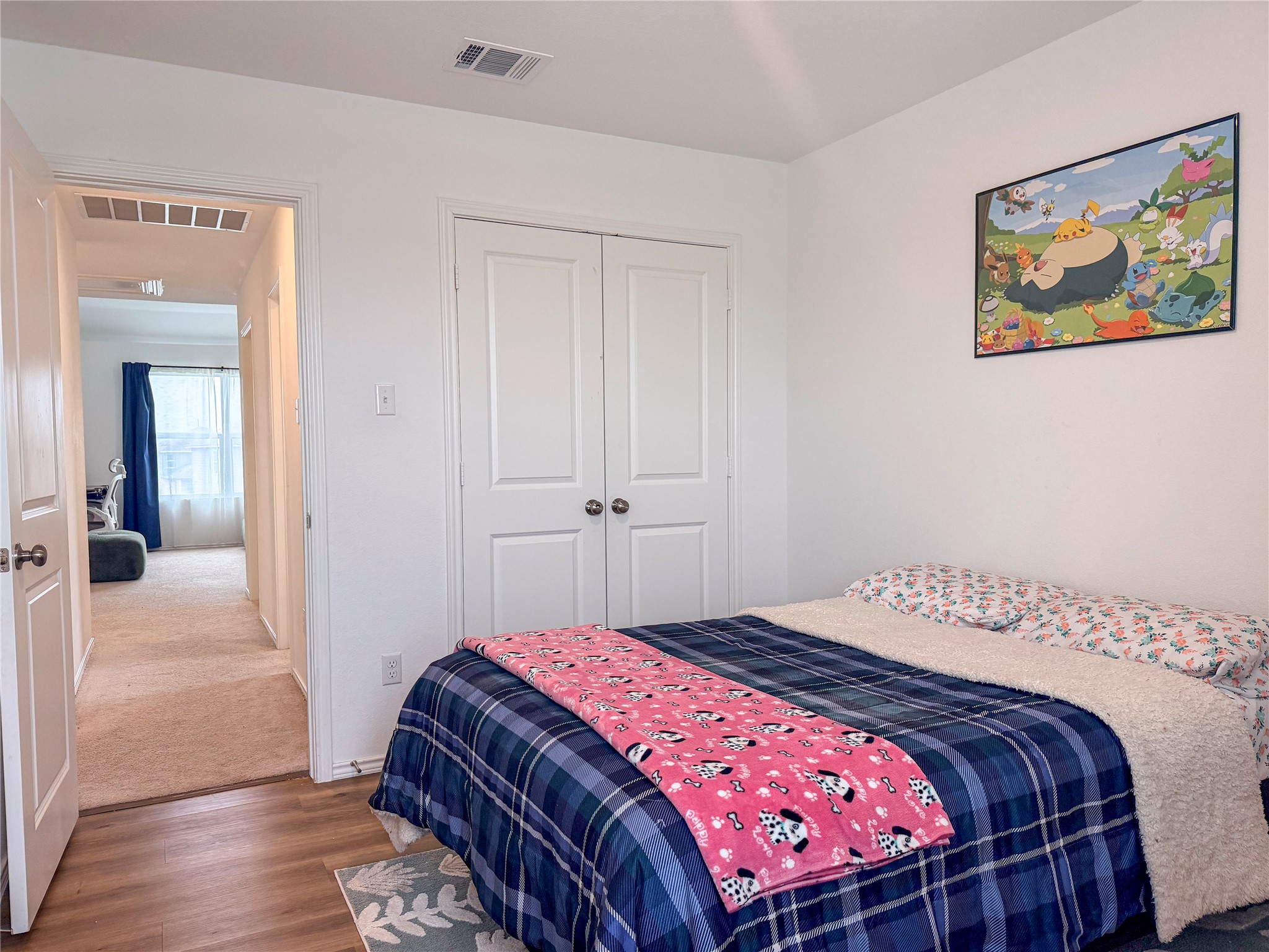 400 Canley Loop Hutto, TX 78634 - Photo 16 of 20 a bedroom with a bed and painting on the wall
