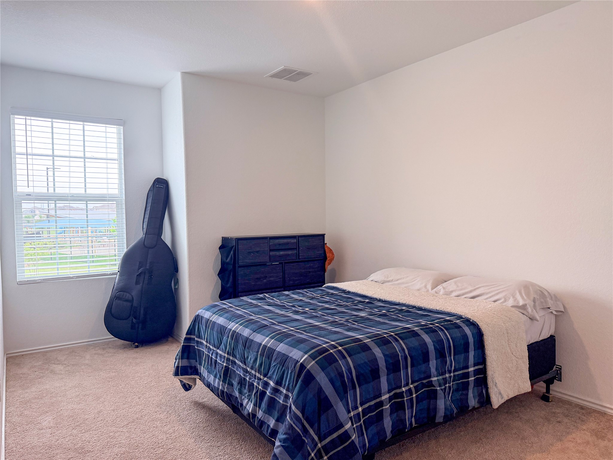 400 Canley Loop Hutto, TX 78634 - Photo 17 of 20 a bedroom with a bed lamp and a window