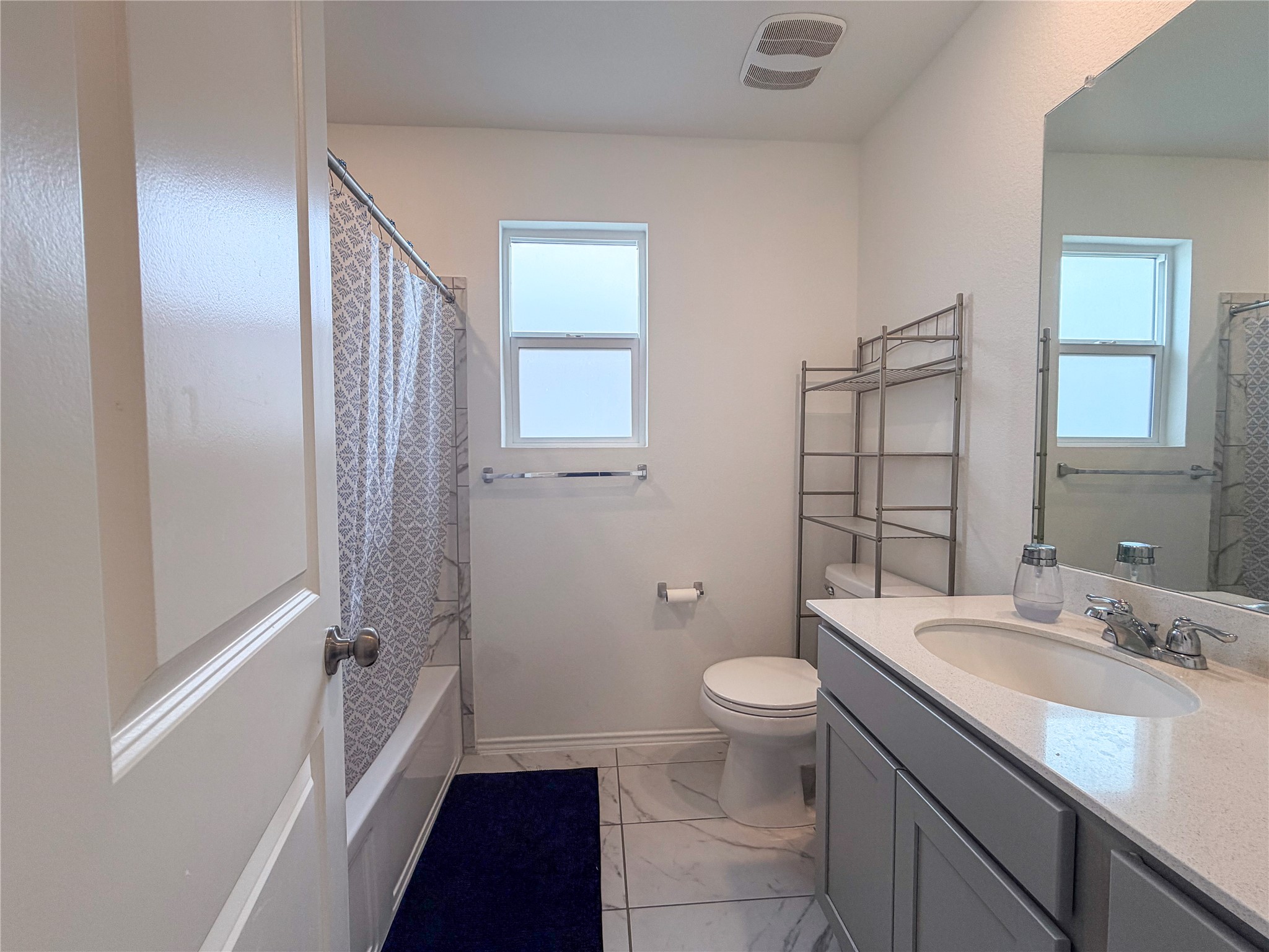 400 Canley Loop Hutto, TX 78634 - Photo 18 of 20 a bathroom with a granite countertop sink toilet and shower