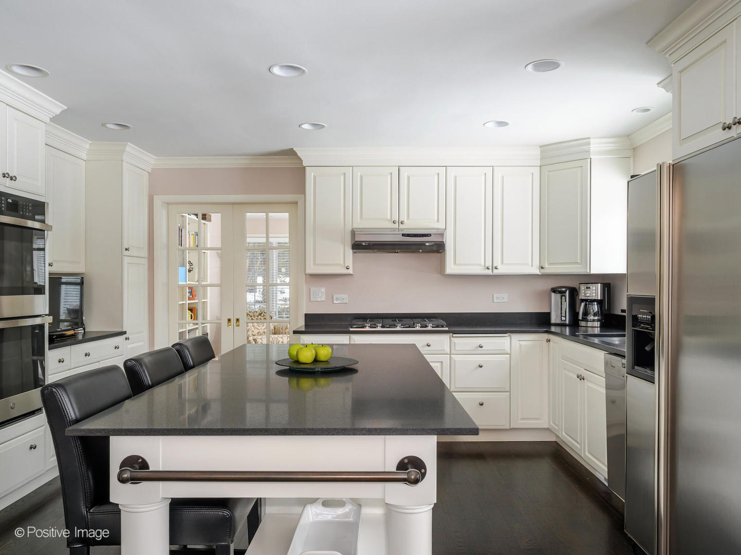 2775 Sheridan Road Evanston, IL 60201 - Photo 11 of 27 a kitchen with a sink a stove a refrigerator and white cabinets