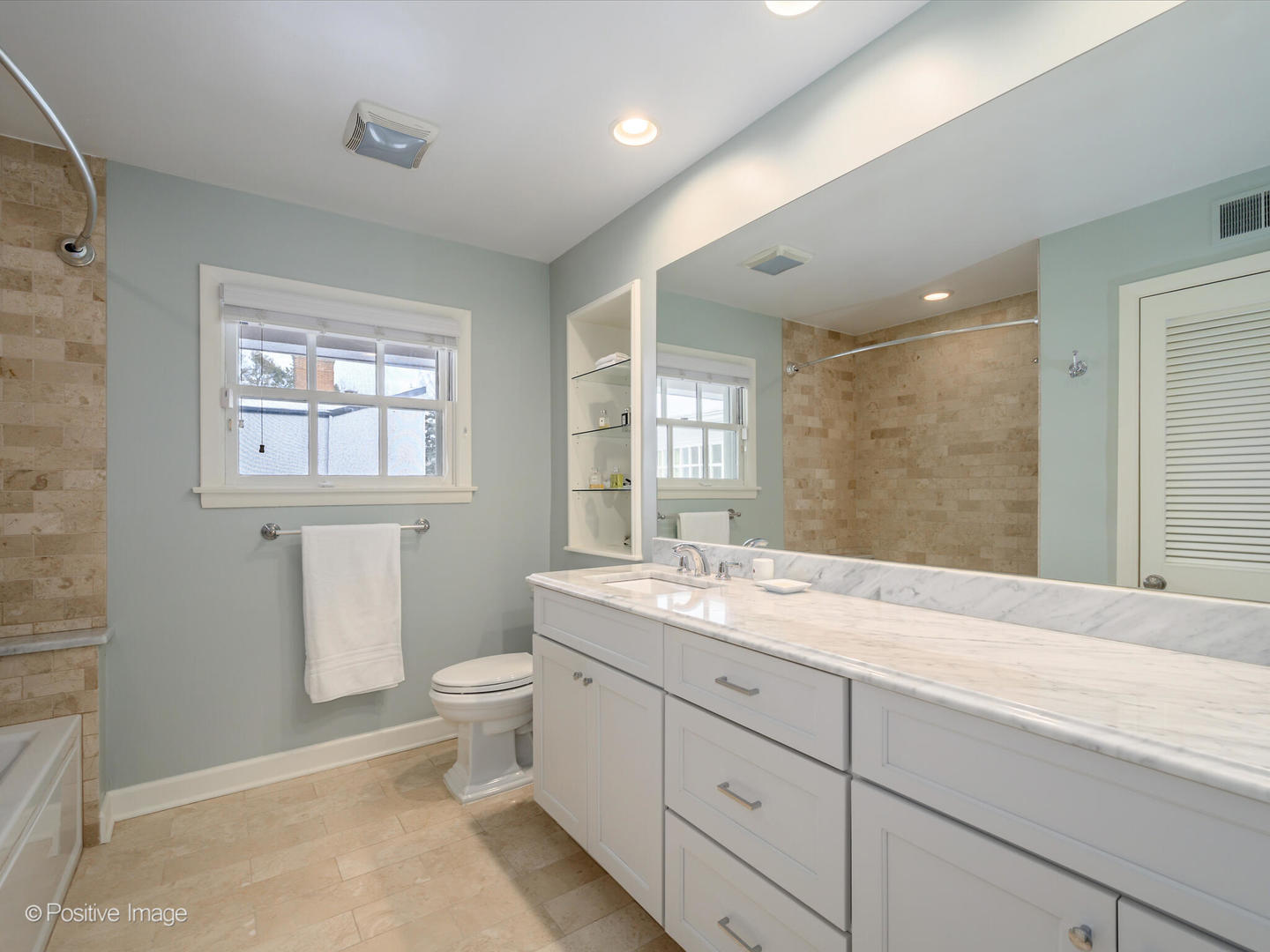 2775 Sheridan Road Evanston, IL 60201 - Photo 21 of 27 a spacious bathroom with a granite countertop sink toilet and mirror