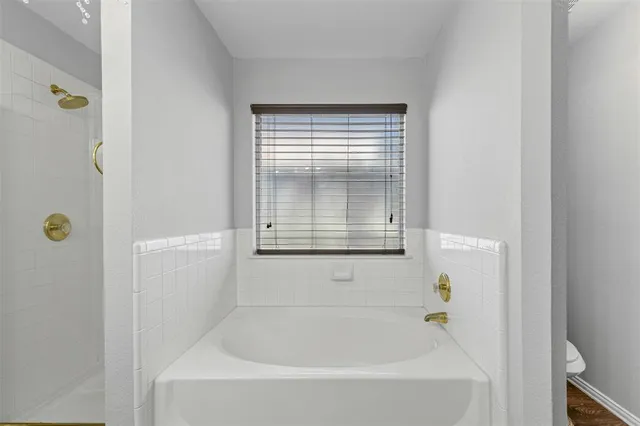 a white bath tub sitting next to a window