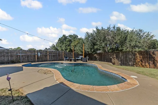 a view of a swimming pool with a yard