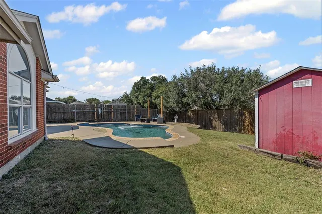 a view of a backyard with swimming pool