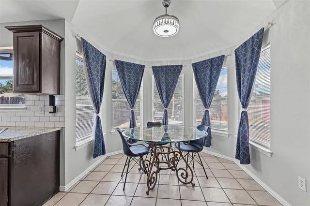 a view of a dining room with furniture and window