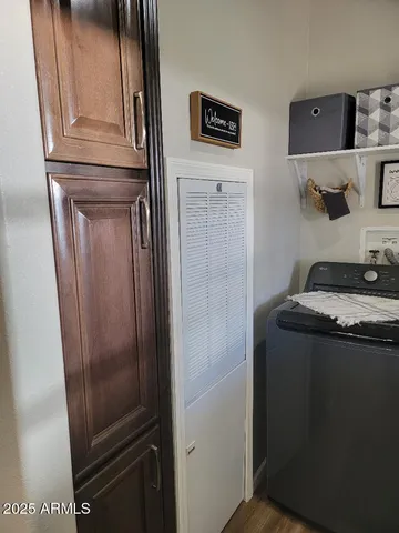 a bathroom with a granite countertop sink and a refrigerator