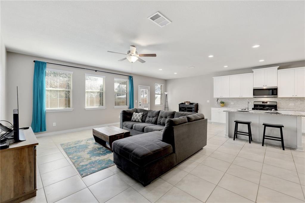 204 Tulum Terrace Leander, TX 78641 - Photo 8 of 22 Living area with a ceiling fan, light tile patterned floors, and recessed lighting